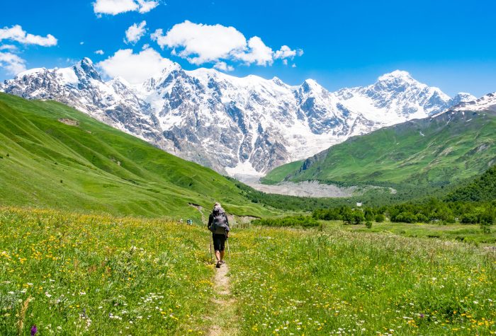 Tourist with a backpack in Caucasus mountains. Svaneti region, Georgia